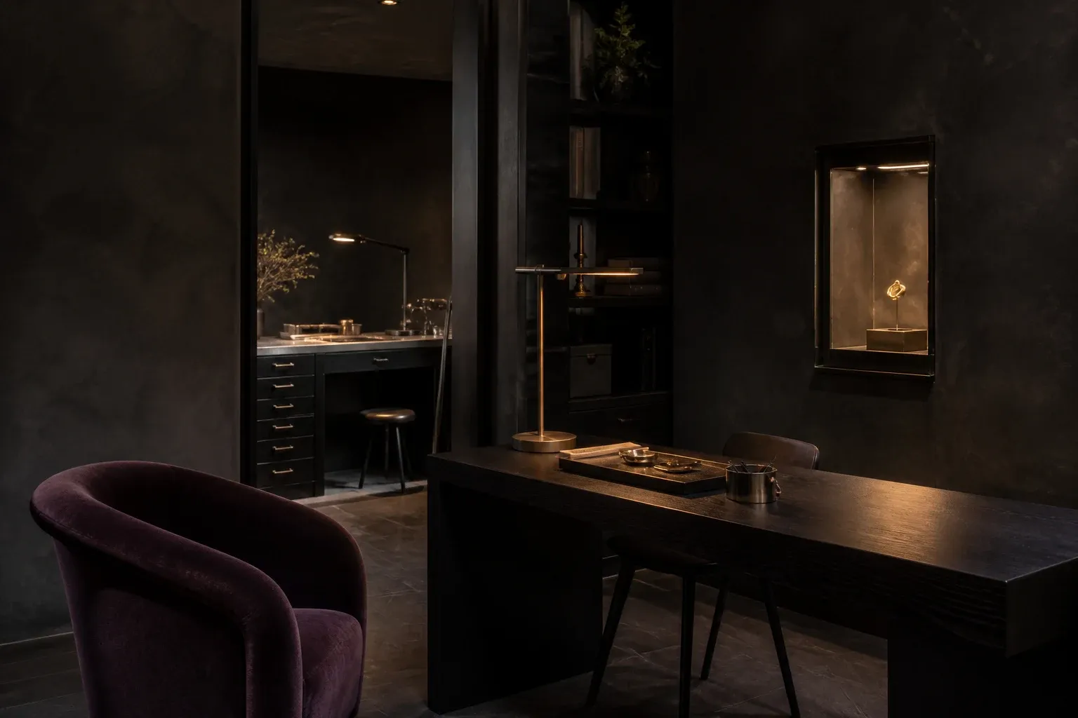 Intimate Atelier Gold salon with aubergine velvet and warm gallery light
