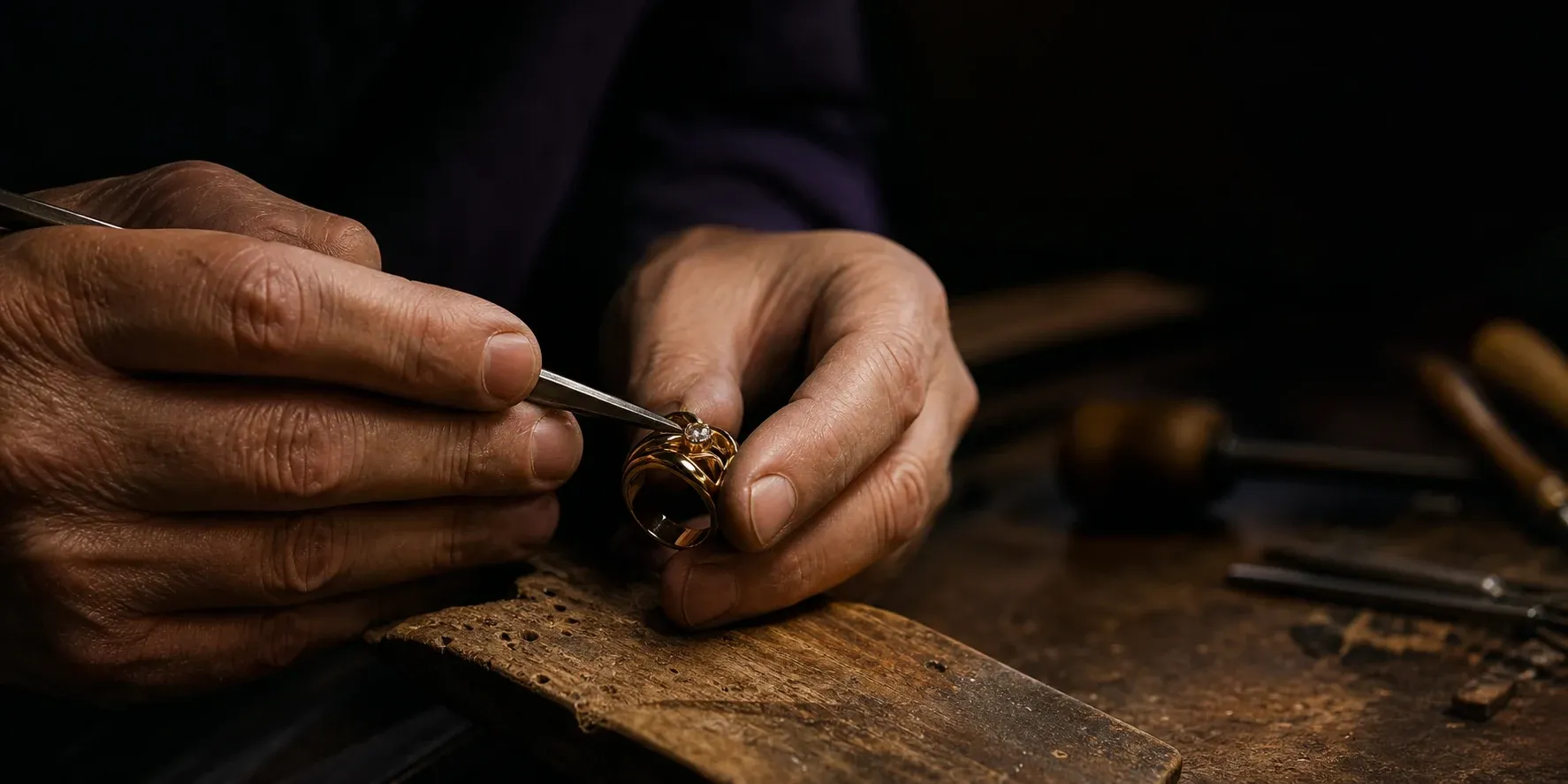 Jeweler setting a diamond by hand at the bench